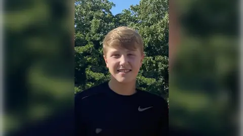 Family handout Matthew Daulby smiling at the camera, wearing a black Nike t-shirt, he has blonde short hair and light eyes. 