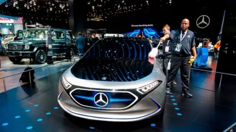 Getty Images A man cleans the Mercedes-Benz concept EQA show car at the 2018 North American International Auto Show (NAIAS) in Detroit, Michigan, on January 15, 2018.