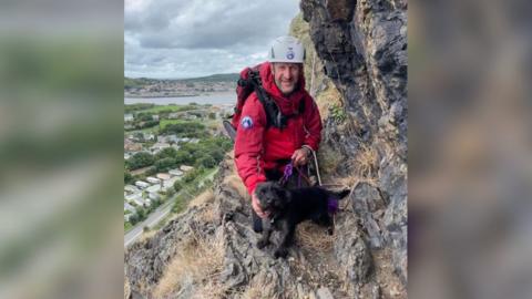 Dog with mountain rescue volunteer