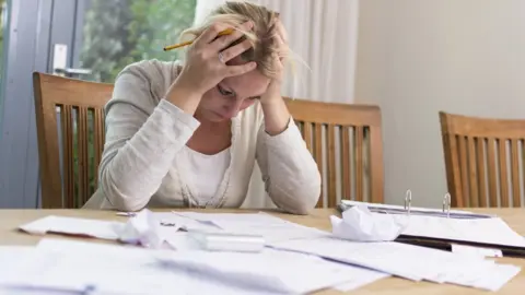 Getty Images A woman going through her finances