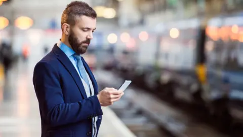 Getty Images Man waiting at train platform