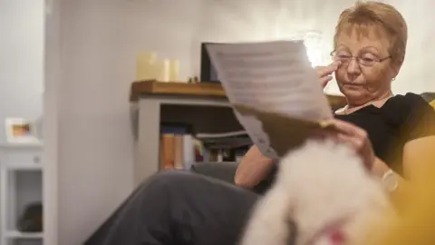 Getty Images A woman getting emotional as she reads letter