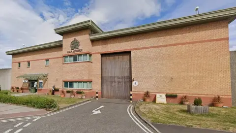 Exterior view of HMP Altcourse prison on a cloudy day.