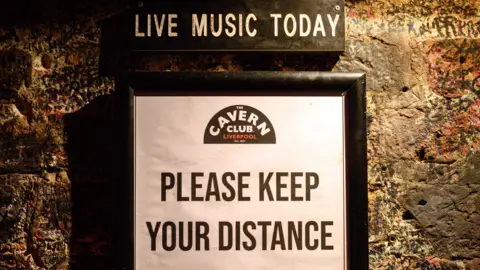 Getty Images "Please keep your distance" notice at the Cavern Club in Liverpool in August 2020