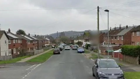 Google Road running through centre of image flanked by semi detached houses.