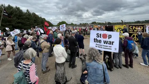 Jon Ironmonger/BBC Protestors at an event in Lakenheath, Suffolk