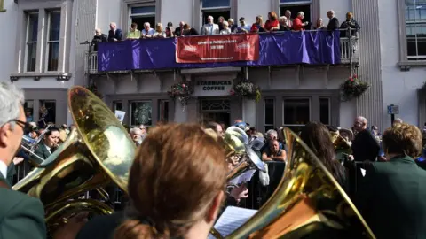 AFP/GETTY Images Bands parade past Corbyn