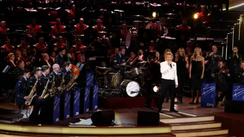 PA Media Rod Stewart performs with a big band behind him.