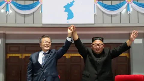 Reuters/Pyongyang Press Corps Moon Jae-in and Kim Jong-un raise held hands aloft