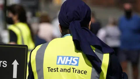 Christopher Furlong/Getty Images Man wearing NHS Test and Trace vest