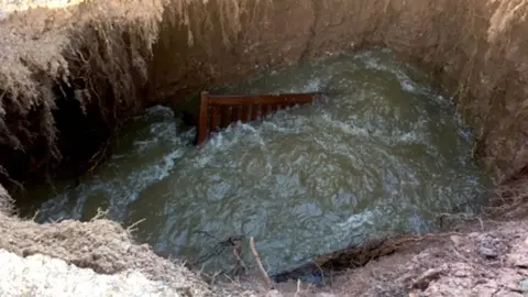 Exeter City Council Memorial bench at bottom of sinkhole