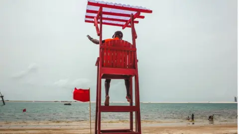 BBC Stephen Boboly on lifeguard chair on Landmark Beach, Lagos, Nigeria