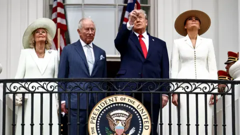 US President Donald Trump, first lady Melania Trump, King Charles III and Queen Camilla watch a flyover of military planes from the Blue Room balcony during an arrival ceremony at the White House on day two of the State Visit of King Charles III and Queen Camilla to the United States of America, on April 28, 2026 in Washington, DC