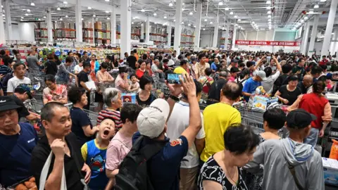 Getty Images People visit the first Costco outlet in China, on the stores opening day in Shanghai on August 27, 2019