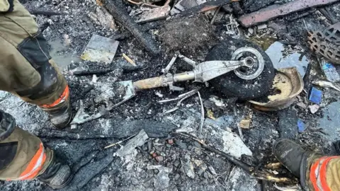 Gresham Fire/Facebook A photo shared by the Gresham Fire department appears to show a plane's wheel among the debris