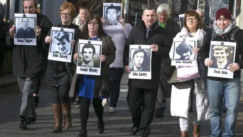 Colm Lenaghan/ Pacemaker Press Families of those killed in Ballymurphy with images of their relatives