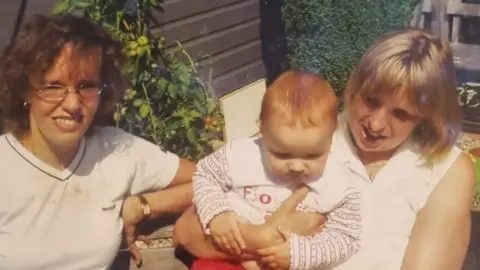 Family handout Two women, one of whom is holding a baby, old photo