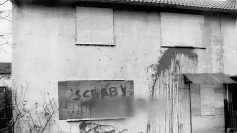 Getty Images A worked miner's house in Bolton upon Dearne, South Yorkshire, boarded up and daubed with graffiti