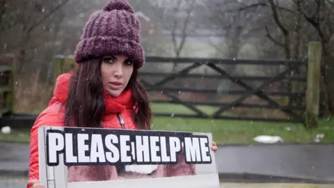 Vegan campaigner holding a placard