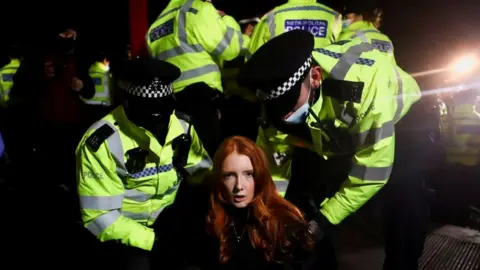 Reuters Police at Clapham Common handcuff a woman