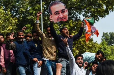 AFP/Getty Images Congress Party members shout slogans against billionaire jeweller Nirav Modi