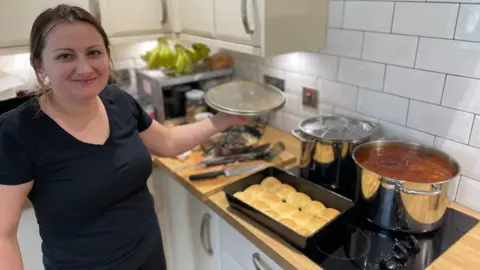 BBC A Ukrainian woman makes borscht - a traditional eastern European soup - at the facility in Clarkston