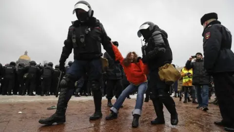 EPA Russian special police units officers detain a female protester in St Petersburg