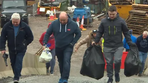 Workers leaving the meeting today