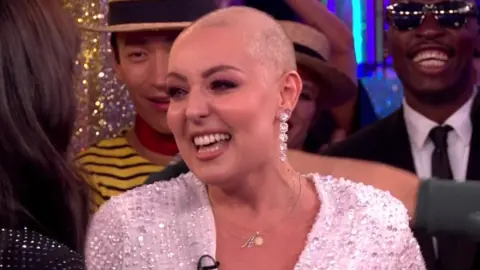 Amy Dowden surrounded by Strictly Come Dancing cast members on Saturday night's show