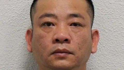 Custody image of Hai Nguyen in front of a white wall, with a serious expression and cropped close to his face