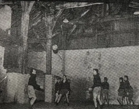 Burnley FC Archives A grainy archive black and white picture showing seven players from Burnley FC playing inside the great barn. They are looking at the ball which is in the air by the pillars that support the roof