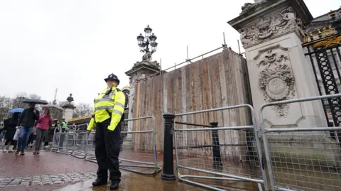 PA Media Scaffolding in place after a man was arrested after crashing his vehicle into the gates of Buckingham Palace, London. Armed officers arrested the man at the scene on suspicion of criminal damage and he was taken to hospital, the Metropolitan Police said. Scotland Yard said his car "collided with the gates" of the royal residence at 2.30am on Saturday. Picture date: Sunday March 10, 2024.