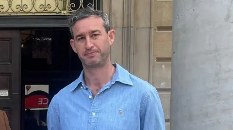 Joe Griffin/LDRS A man with short grey hair. He is wearing a blue denim shirt and is looking into the camera.
