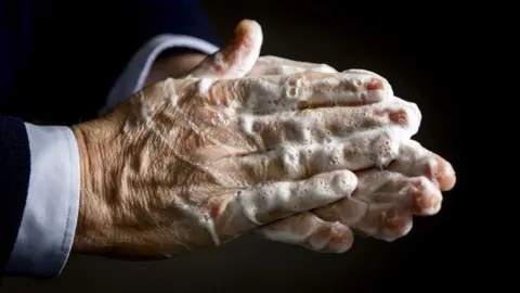 EPA Sudsy hands are clasped together in a handwashing motion.