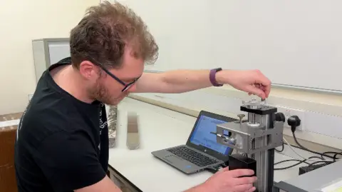 Dr Tim van Peer working in a lab at the University of Leicester