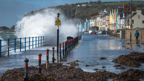 Noreensireland/BBC Weather Watchers A wave crashes against a wall on the coast of Northern Ireland on Thursday as Storm Storm Éowyn approached