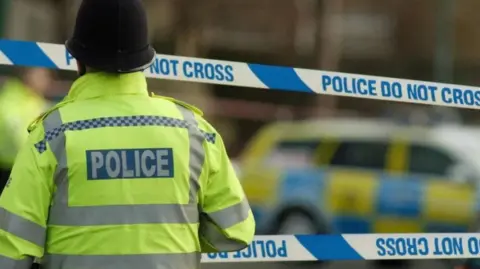 Getty Images Anonymous police officer and police tape