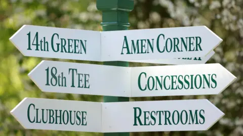 A sign at Augusta National Golf Club showing directions to Amen Corner, the 18th tee, concessions, the clubhouse and restrooms
