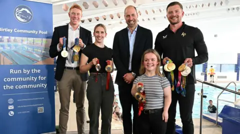 Reuters Prince William poses in the middle of British Olympians and Paralympians Adam Peaty, Tom Dean, Maisie Summers-Newton and Louise Fiddes, by the side of the swimming pool.