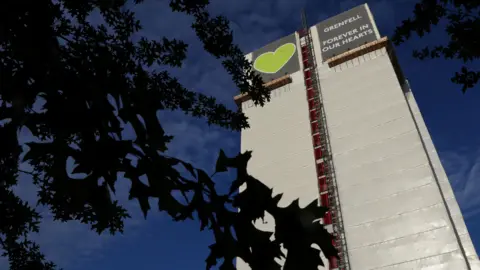 Reuters Grenfell Tower, a high rise block covered in white material 