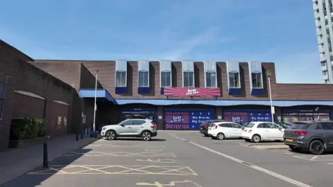 B&M car park. There are five cars parked outside