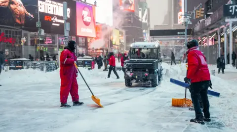Teams work to clear the snow in New York City