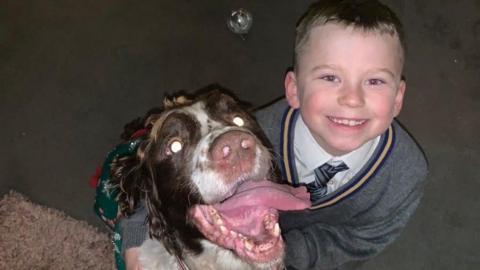 Eight-year-old Elliot with PD Sam