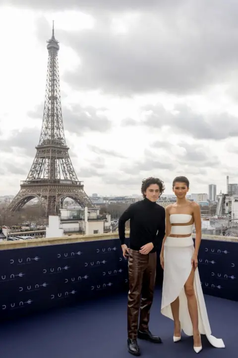 Getty Images Chalamet and Zendaya pose in front of the Eiffel Tower while promoting the film in Paris