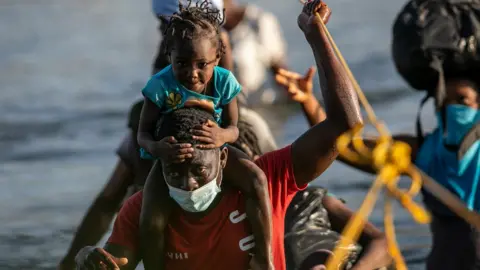 Getty Images Migrants cross Rio Grande