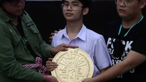 Reuters Student leaders install a plaque declaring "This country belongs to the people" during a mass rally