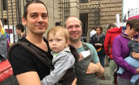 Jörg (L) and Patrick with children