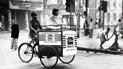 Glenn Edwards A man rides a bike through the streets of Calcutta in the 1980s