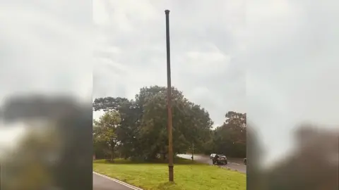 Mike Gutsell Tall metal pipe on a grassy patch