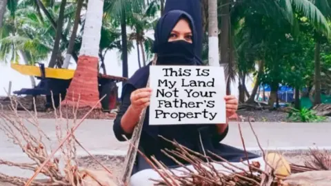 BBC A woman protesting in Lakshadweep